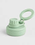 A light mint green reusable water bottle lid with a flip-up carrying loop, shown on a clean light gray background.