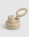 A beige reusable water bottle lid with a flip-up loop handle and textured screw cap, shown on a clean light gray background.