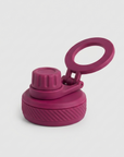 A magenta reusable water bottle lid with a flip-up carrying loop, shown on a light gray background.